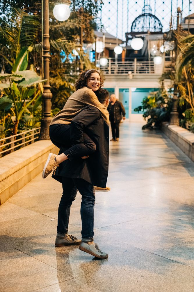 Man carrying happy girlfriend on back