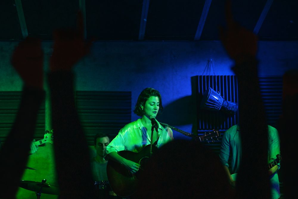 Musicians In Stage With Colorful Lights Performing In A Live Concert