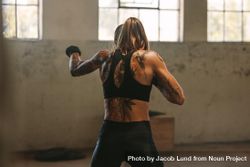 Woman In Sportswear Practicing Shadow Boxing At A Fitness Space Inside Abandoned Warehouse