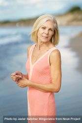 Vertical composition of calm mature woman standing near coast 48yp7b