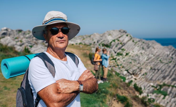 Man in foreground of his hiking crew enjoying view