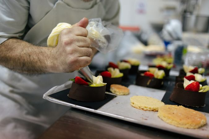 Pastry chef using a pastry bag