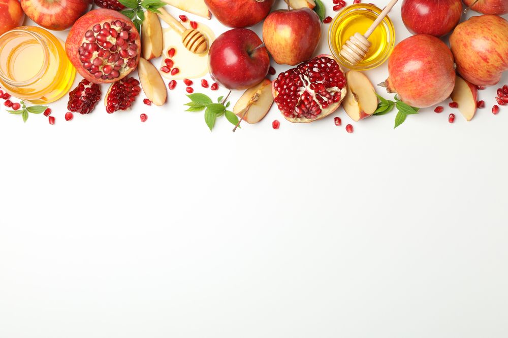 Row of pomegranate with apples honey and mint leaves with copy space