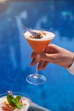 Crop person with glass of drink in hand