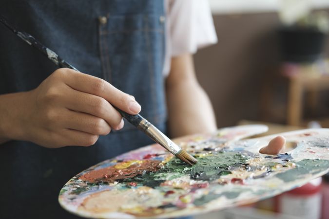 Crafting Inspiration: Female Artist Sketching and Painting in Workshop
