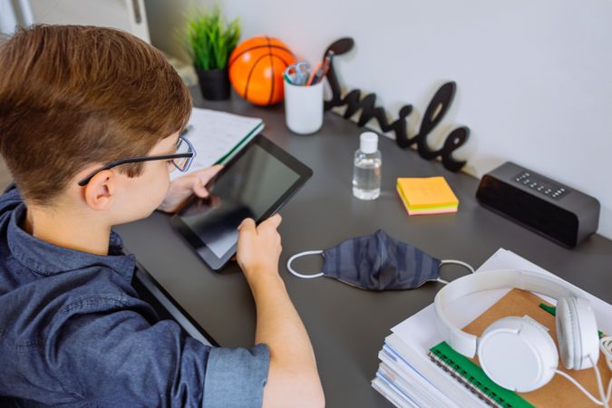 Teenager doing homework with a tablet