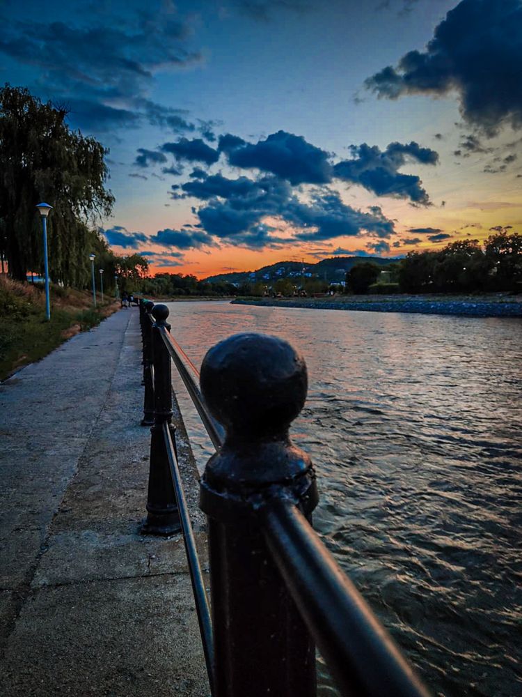 Sunset on a river with a walkway