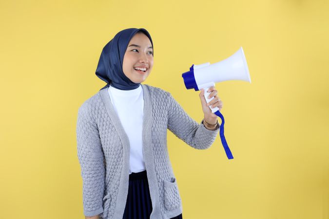 Young Asian Muslim Woman Shouting using Megaphone