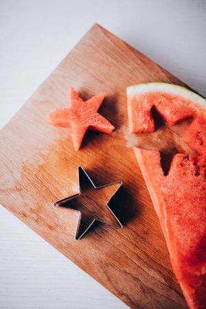 Cut out watermelon star on wooden cutting board