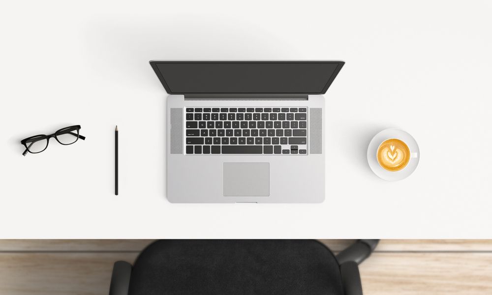 Modern workplace with laptop and smartphone copy space on table background. Top view. Flat lay style.