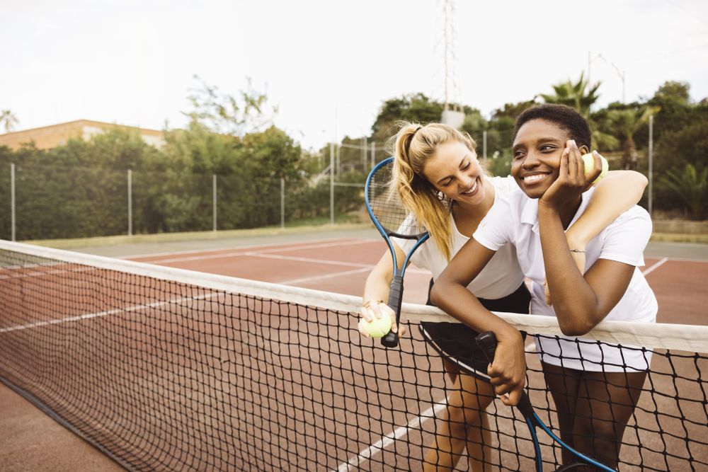Portrait of two young women on a tennis court