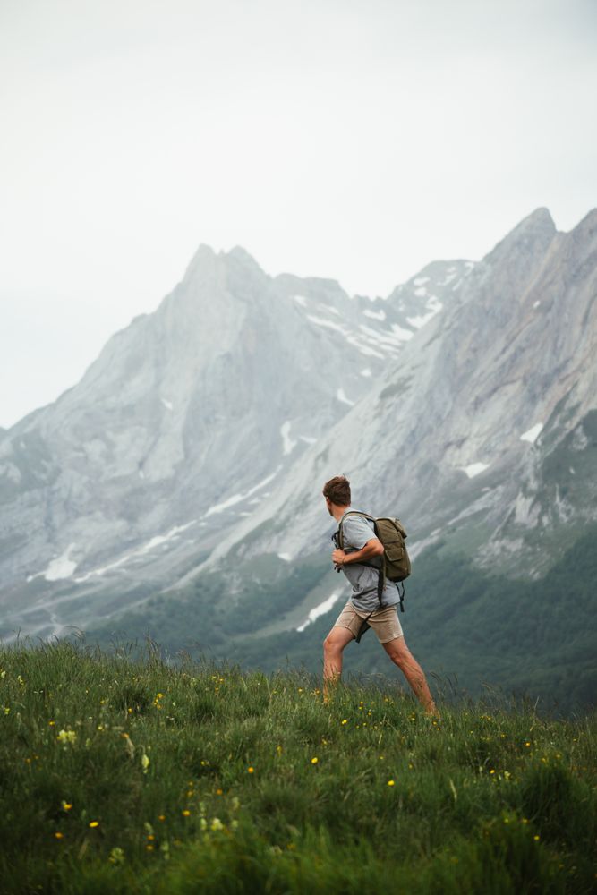 Unrecognizable man with backpack hiking in Pyrenees mountains