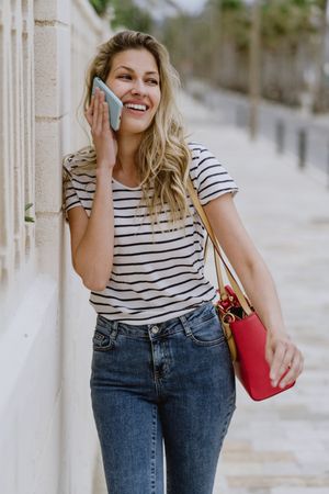 Woman using phone on city street