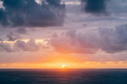 Grassy shore near stormy sea in evening
