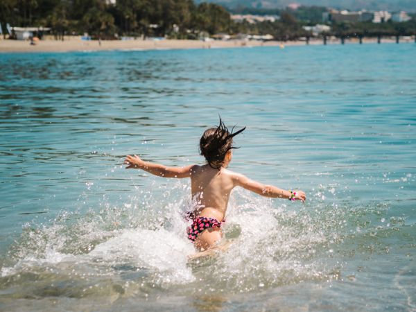 Cheerful girl having fun in warm sea