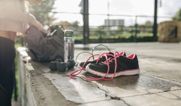 Woman taking sports equipment out of sports bag