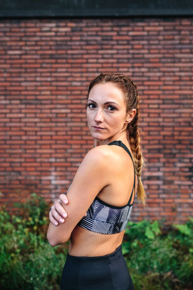 Sporty woman with boxer braids posing