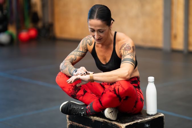 Athlete using a smart watch in a cross training center