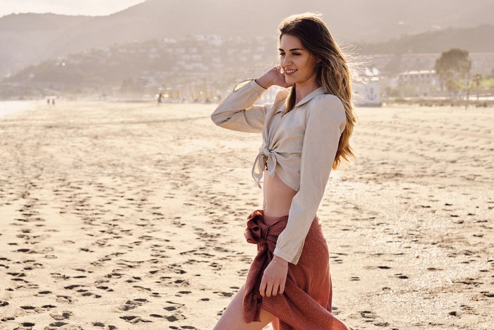 A fashion model at the beach before sunset
