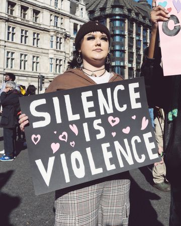 London, England, United Kingdom - March 19 2022: Woman with “Silence is Violence” sign