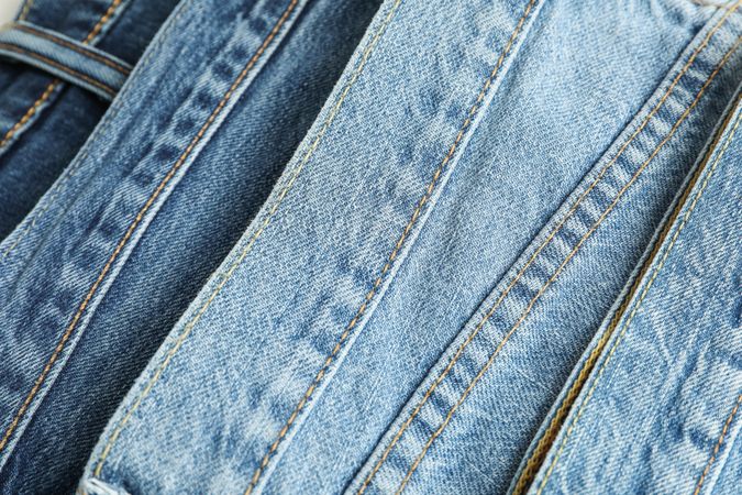 Jeans of different colors as background, space for text