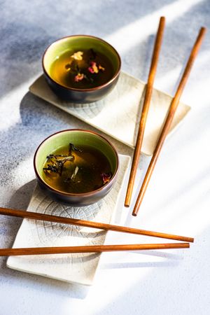 Tea time with two cups of green tea and chopsticks