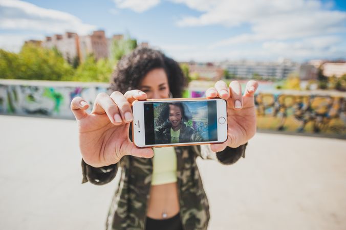 Happy woman taking selfie with phone