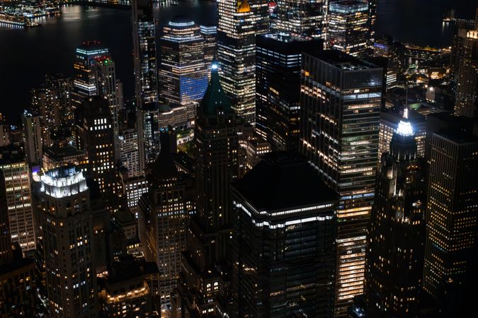 Scenic Aerial New York City View of Downtown Manhattan Architecture. Panoramic Photo of the Business District from a Helicopter. Cityscape with Buildings with Lights in Offices at Night