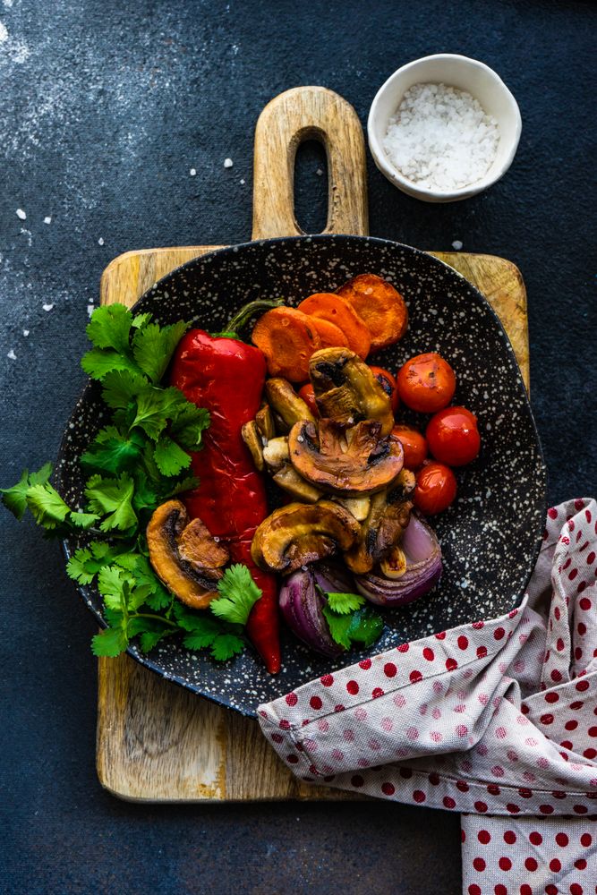 Top view of plate of grilled vegetable on wooden board