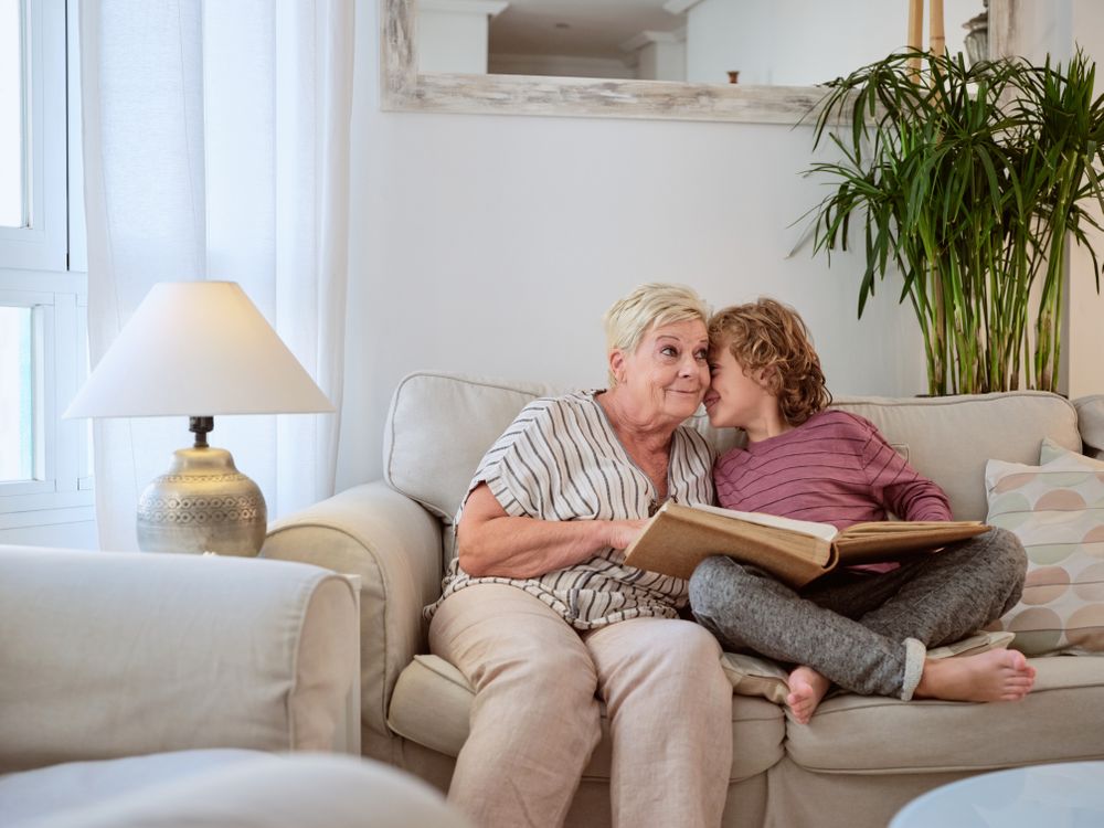 Boy whispering to grandma