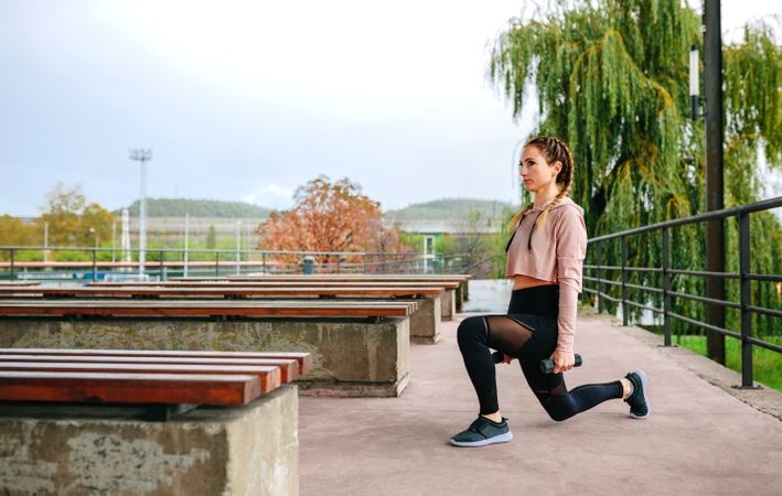 Young woman training with dumbbells