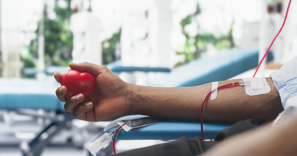 Close Up Shot Of Hand Of Male Blood Donor With an Attached Catheter.
