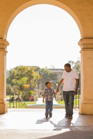 Father and Son Walking Through Arch in the Park