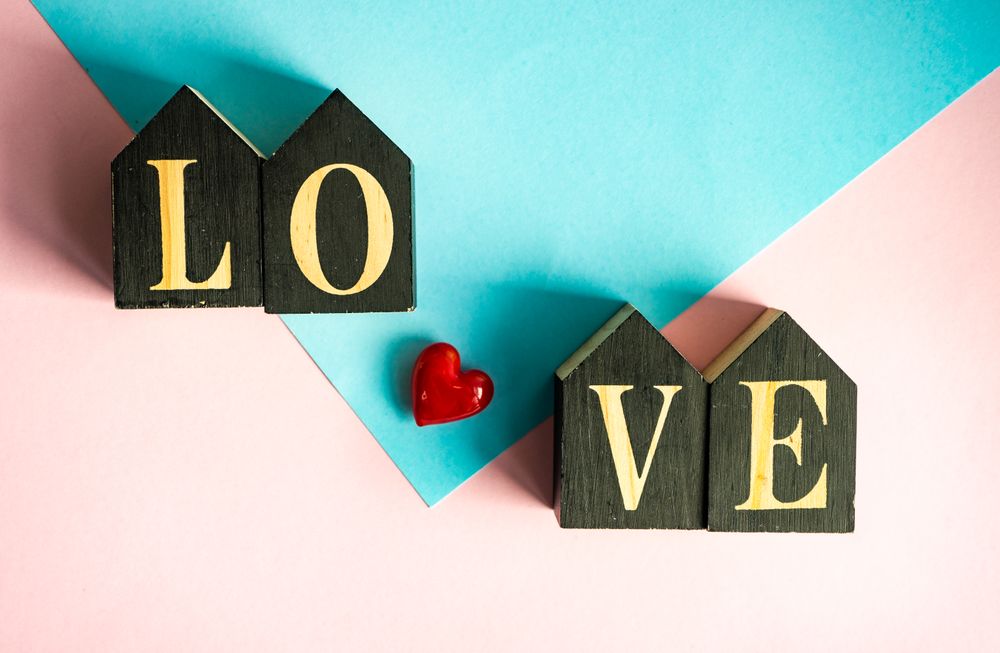 Heart ornaments on pastel pink table 