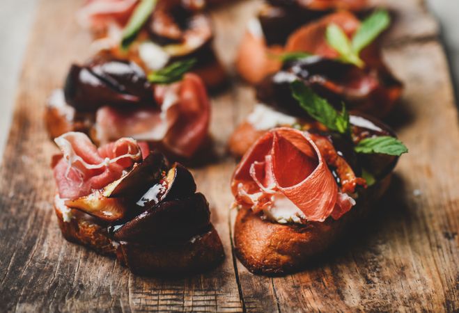 Crostinis with prosciutto, goat cheese and grilled figs, close up