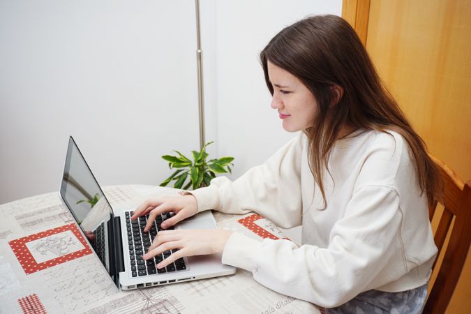 Teenage girl using computer