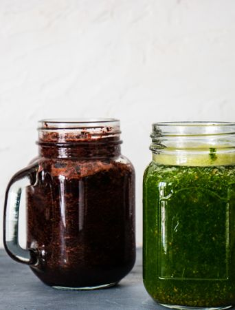 Side view of purple and green smoothie on counter