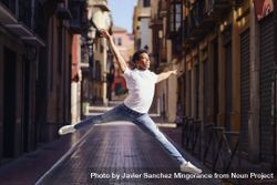 Graceful male dancer leaping on an empty European street 5aeoa5