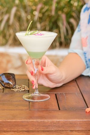 Crop woman with glass of cocktail