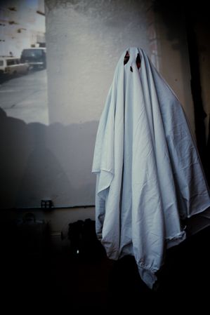 Person in sheet ghost costume for Halloween