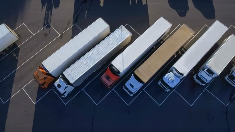 Aerial Shot of  Loading Area where Many Trucks Are Unloading Merchandise