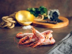 Pile of frozen shrimps on table