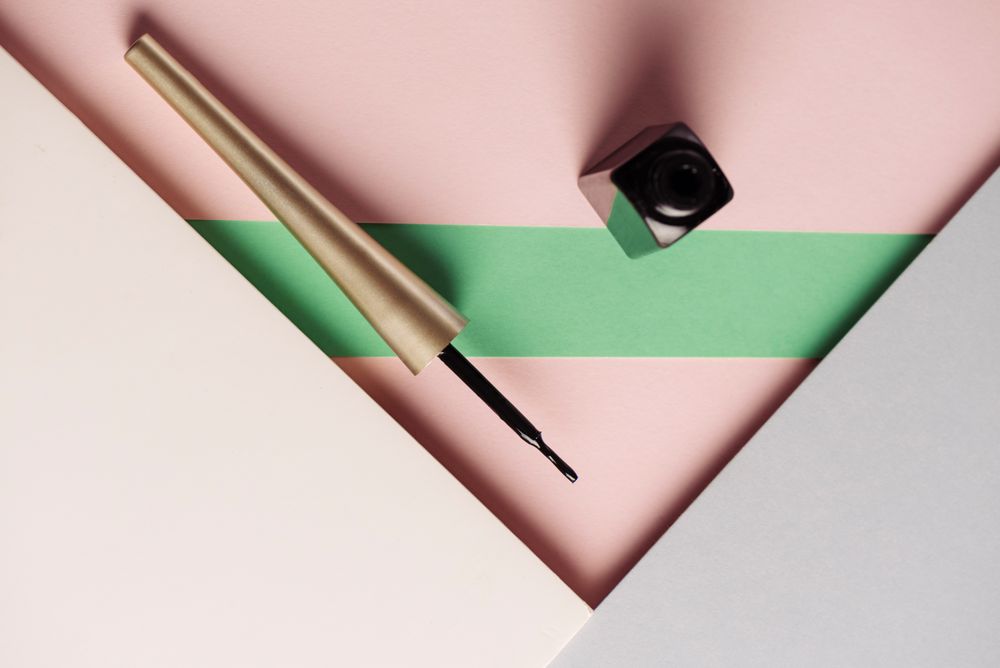 Liquid eyeliner brush on geometric background