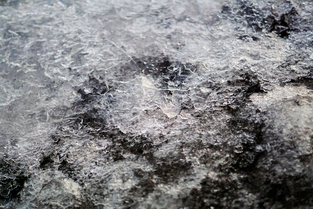 Melted snow crust over rocks