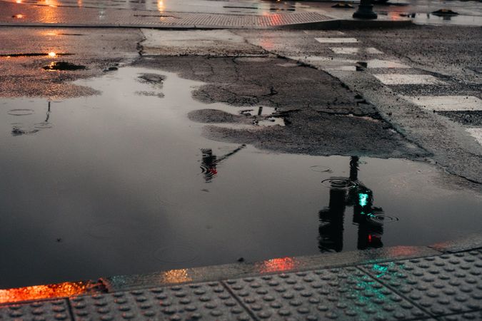 Reflection of traffic light in puddle