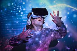 Surprised little boy discovering cyberspace in VR headset