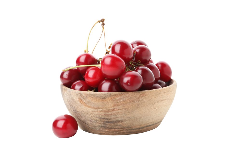ripe cherry fruits in a bowl, isolated on blank background