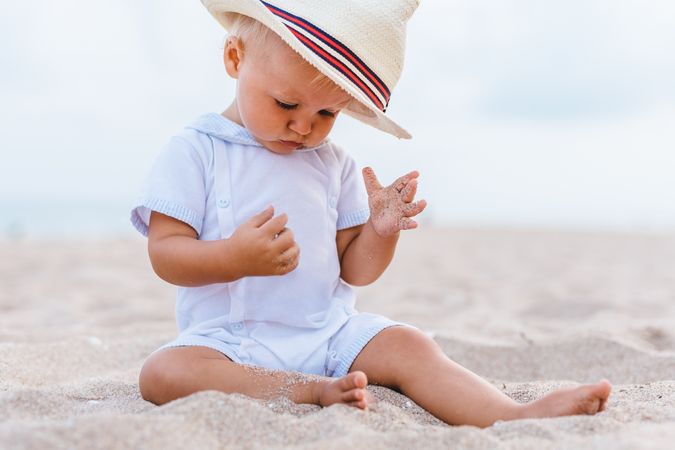 Baby on the beach with hat