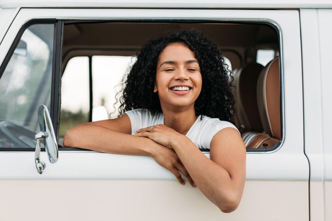 Happy woman looking out of van video with her eyes closed