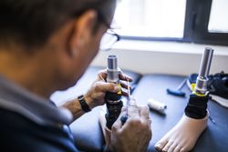man fixing a prosthesis in a workshop